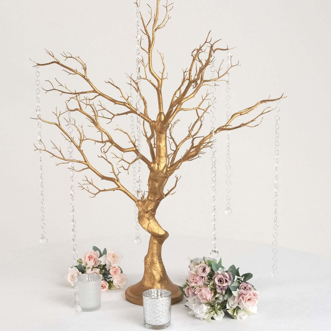 Gold decorative tree centerpiece with hanging crystals and floral arrangements.