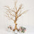 Gold decorative tree centerpiece with hanging crystals and floral arrangements.