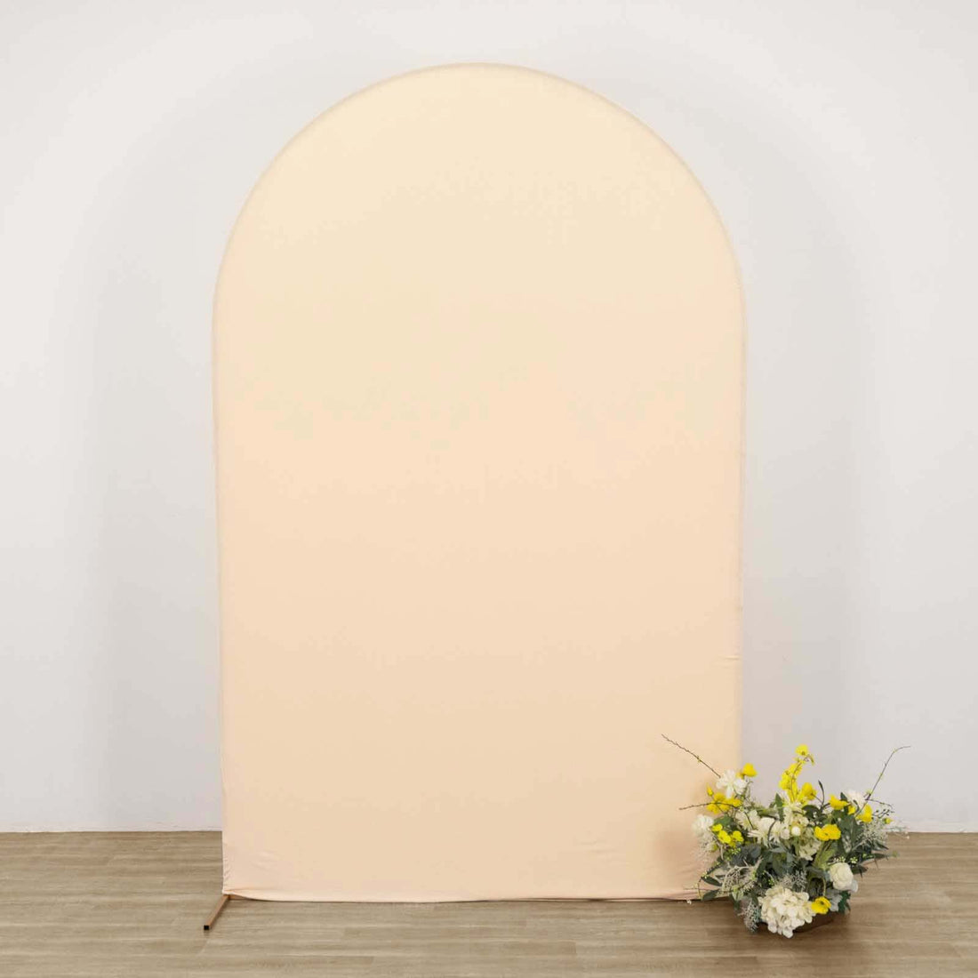 Peach-colored backdrop with floral arrangement at the base.