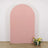 Pink arch backdrop with floral arrangement in front.