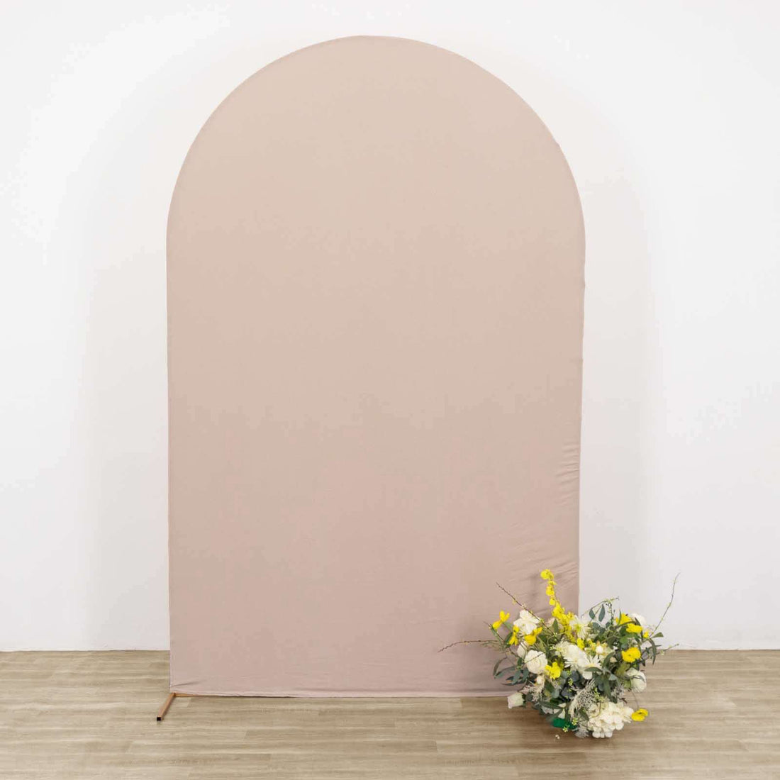 Arch backdrop with floral arrangement in front