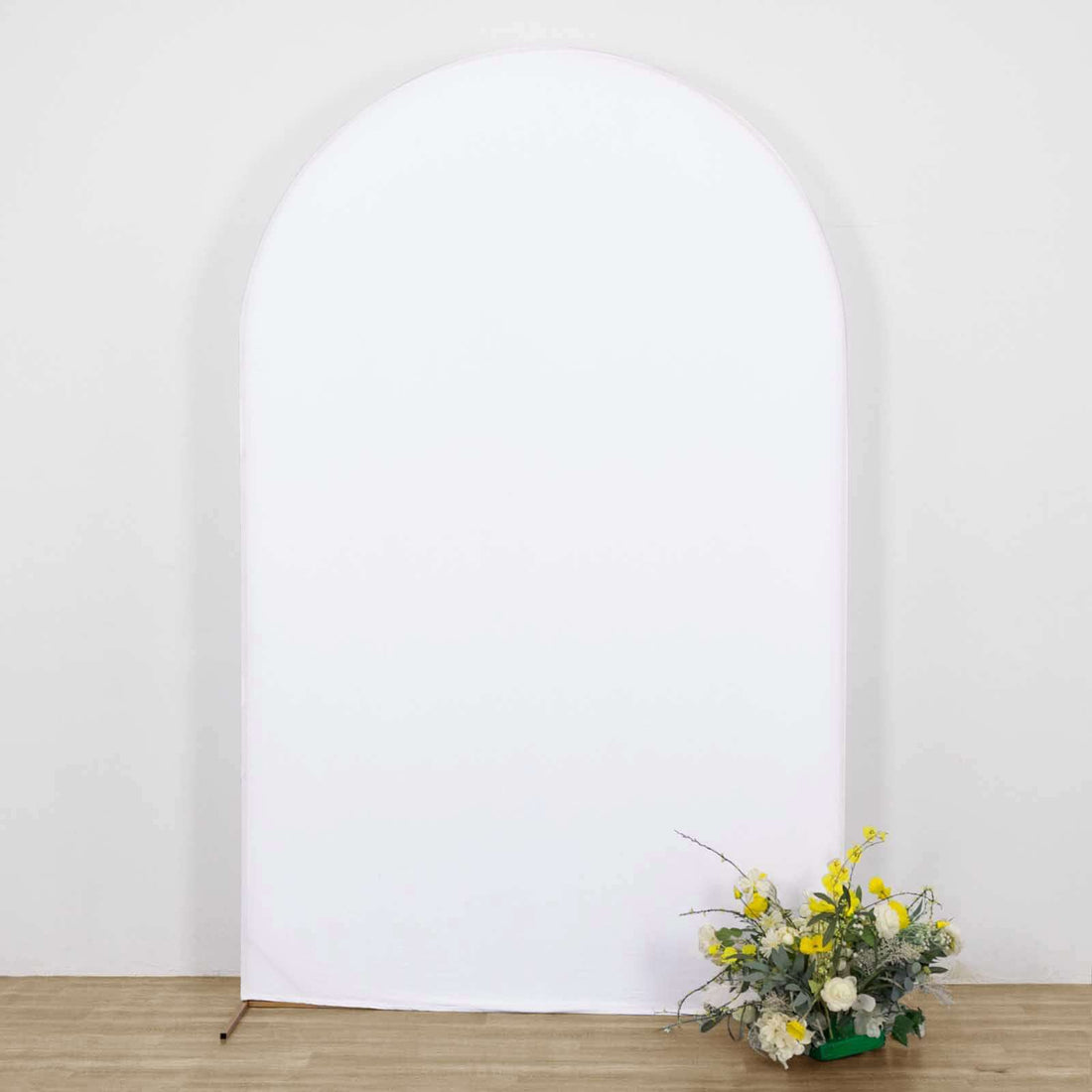 Arch-shaped backdrop with floral arrangement in front