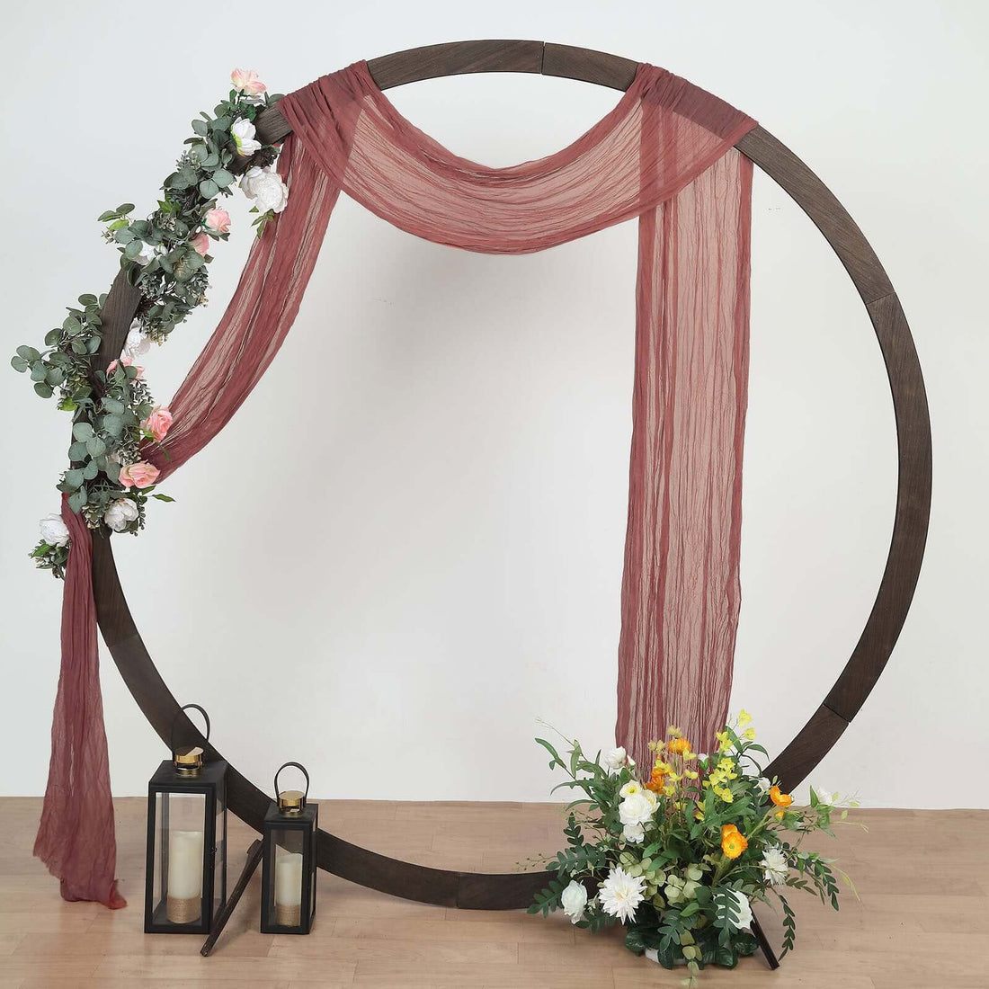 Decorative photo backdrop with floral details and lanterns.