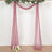 Sheer burgundy drapery with floral accents for event decoration.