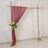 Wooden wedding arch with a burgundy drape and floral arrangement.