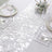 Elegant white table runner with sequins on a beautifully set dining table.