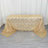 Gold sequin tablecloth with intricate pattern on a table.