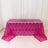 Pink sequined tablecloth on a table against a white backdrop.