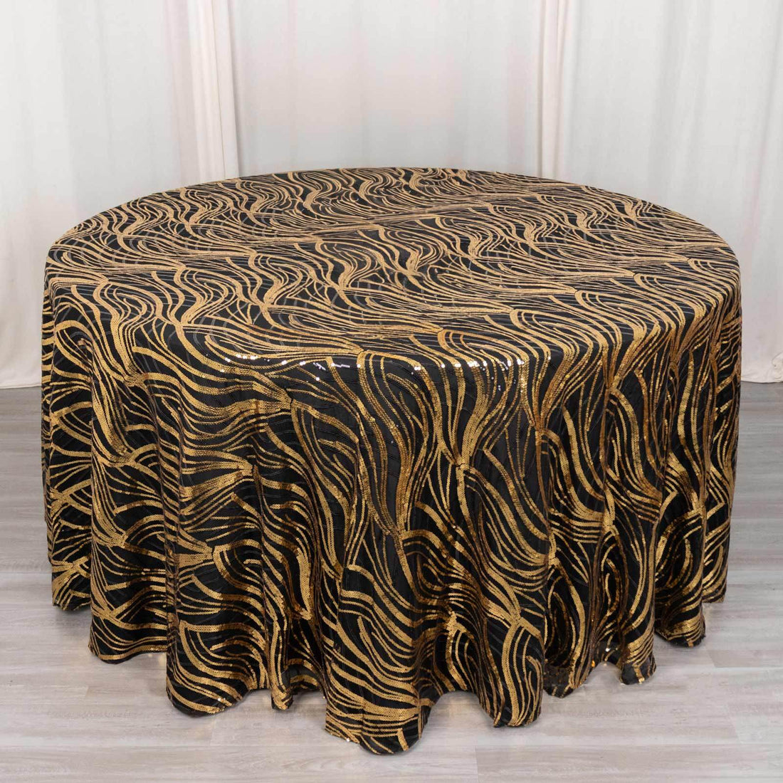Elegant black and gold wave pattern tablecloth for formal events.