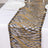 Gold and black sequined table runner on a white tablecloth.