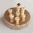 Decorative cupcakes on a mirrored display stand.