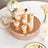 Elegant dessert display with cupcakes and parfaits on a rose gold cake stand.