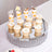 Assorted desserts displayed on a mirrored tray at an elegant event.