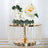Elegant two-tier cake adorned with fresh flowers on a decorative cake stand.