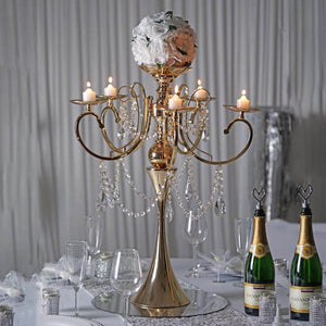 Elegant gold chandelier with floral accents and candles, perfect for events.
