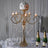 Elegant gold chandelier with floral accents and candles, perfect for events.