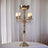 Elegant gold candelabra lamp with crystal accents and four candle holders.