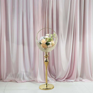 Elegant gold flower stand with a round vase holding soft pastel roses and white blooms.