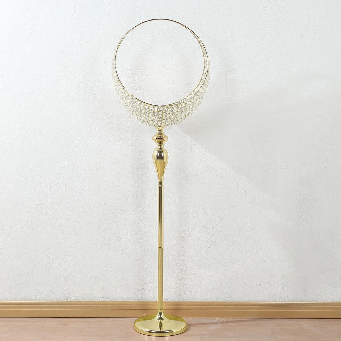 Elegant gold floor lamp with a circular crystal shade design.