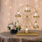 Gold cupcake ferris wheel display with cupcakes and flowers in a festive setting.