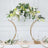 Elegant floral arch centerpiece with white and yellow flowers on a gold stand.