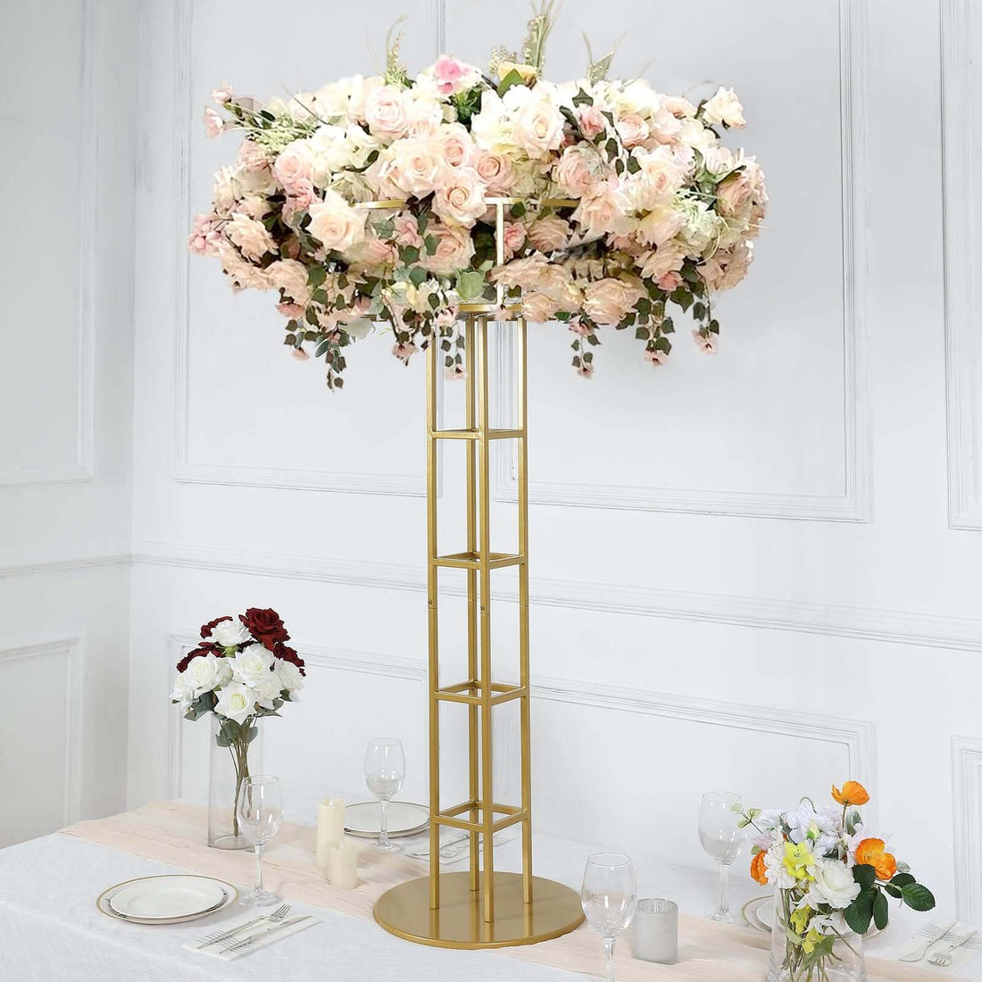 Elegant flower centerpiece on gold stand for event decor.