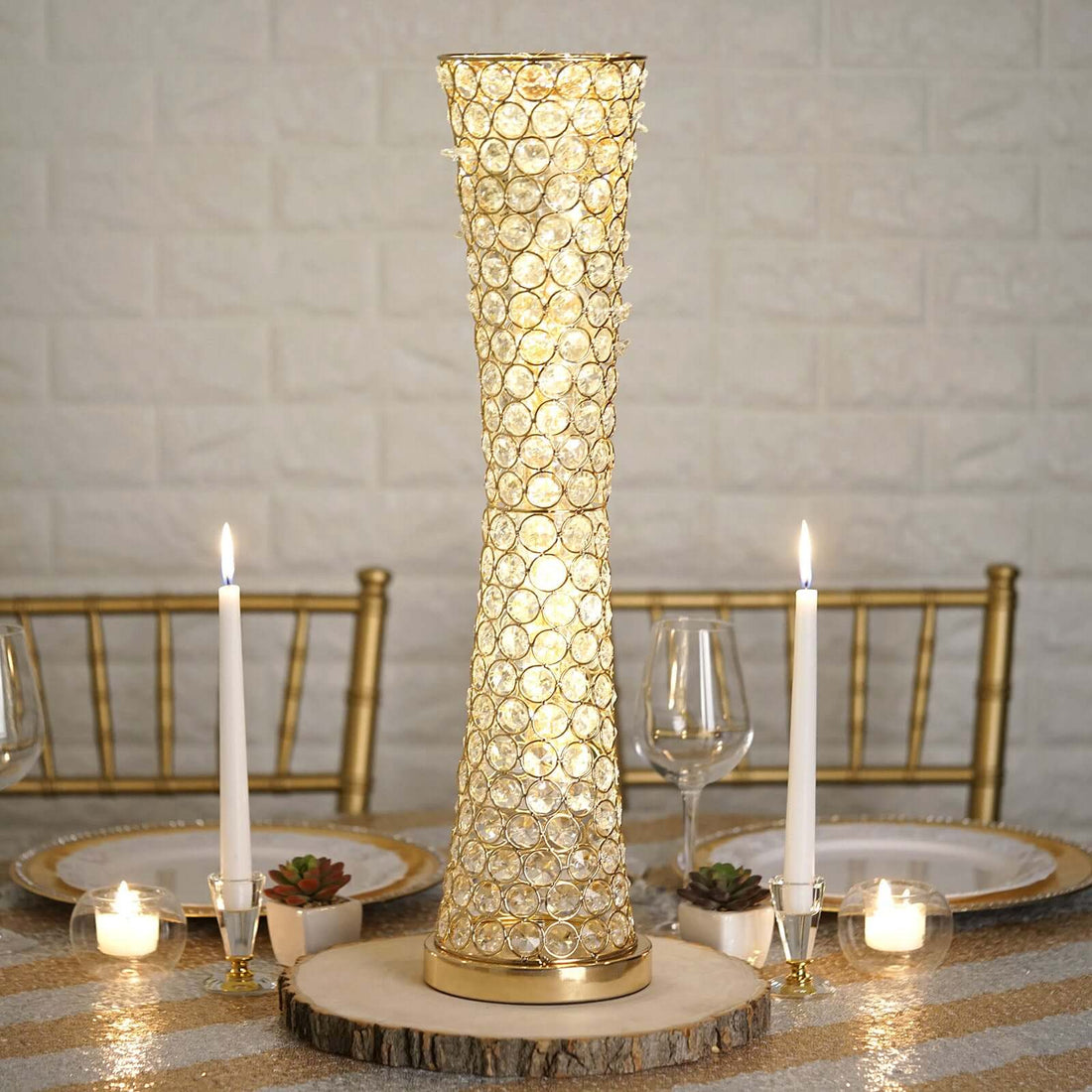 Elegant gold and crystal table lamp on a dining table with candles and decor.