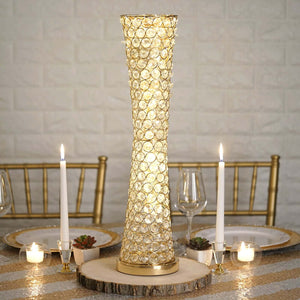Elegant gold and crystal table lamp on a dining table with candles and decor.