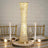 Elegant gold and crystal table lamp on a dining table with candles and decor.