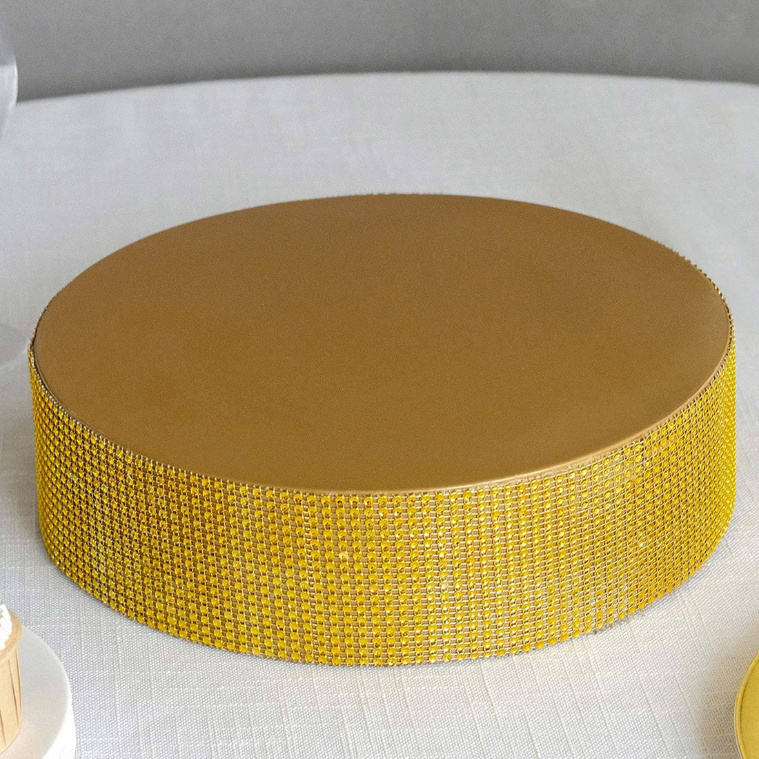 Gold cake board with rhinestone embellishments.