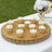 Decorative cupcakes on a gold platter at an outdoor event.