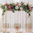 Elegant floral arch with pink and cream roses for wedding decor.