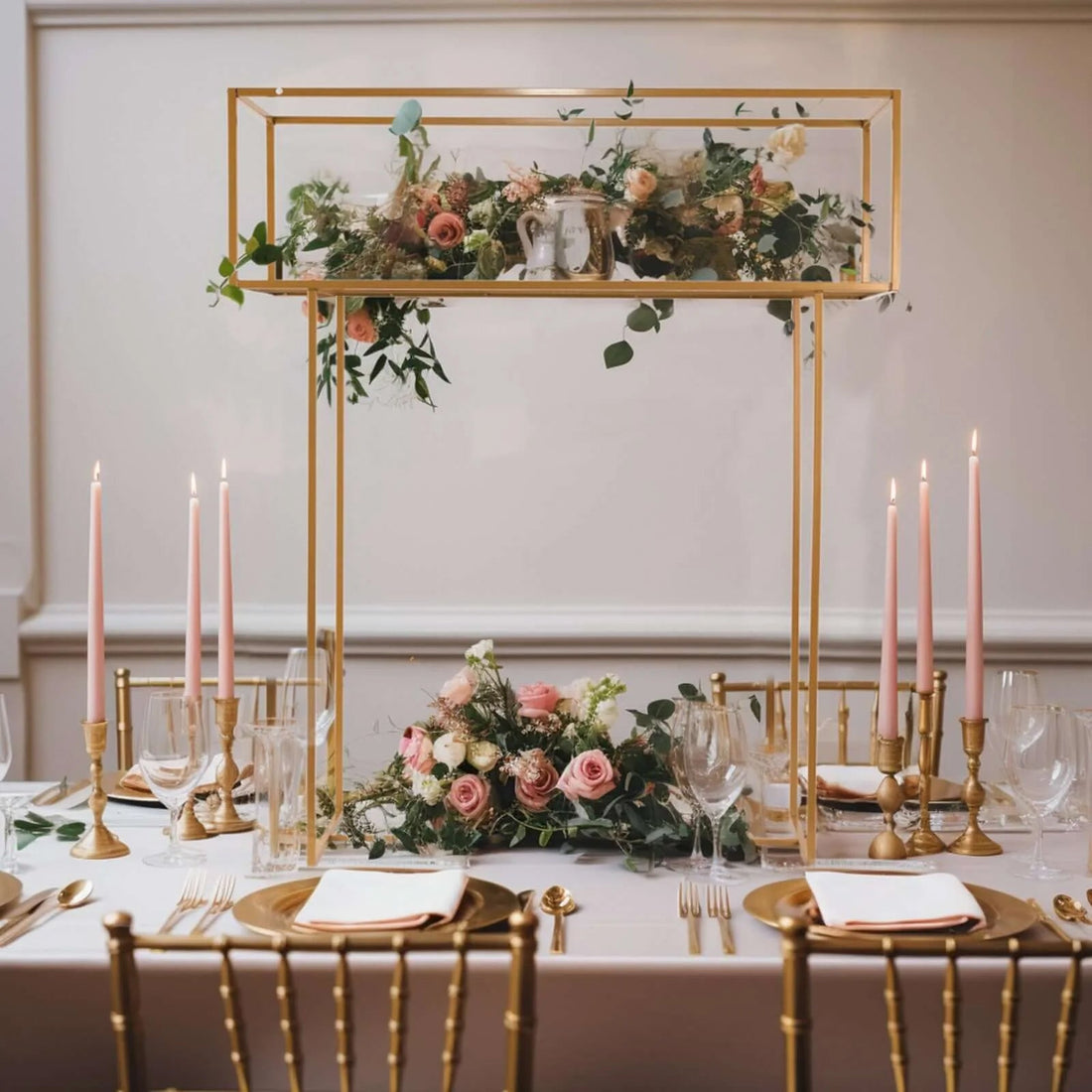 Elegant wedding table centerpiece with flowers and candles in a luxurious setting.
