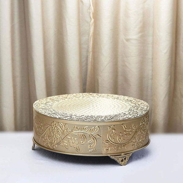 Decorative gold cake stand with intricate floral design.