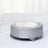 Silver decorative cake stand with intricate floral design.