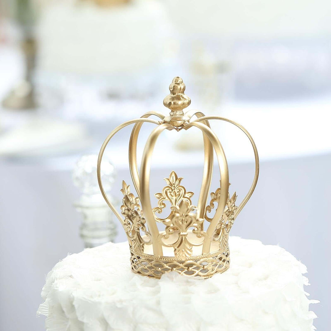 Gold decorative crown on a white table backdrop.
