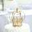 Gold decorative crown on a white table backdrop.