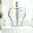 Silver crown decoration for cakes on a white backdrop