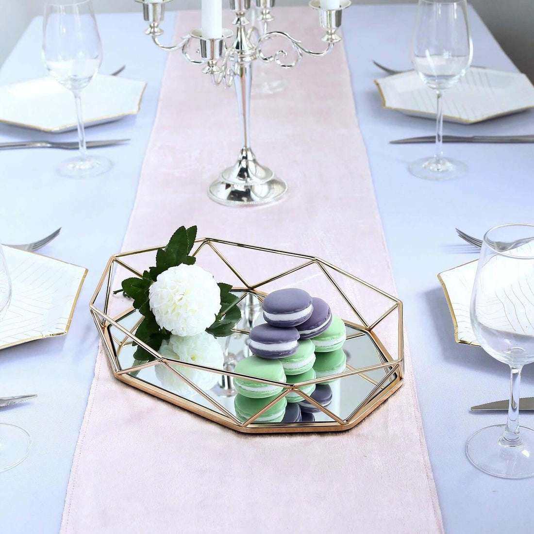 Elegant table setting with macarons and floral decor.