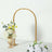 Gold floral arch with white and yellow flowers on a light background.