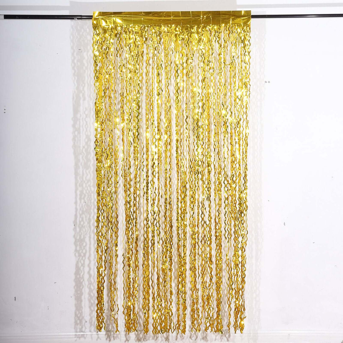 Gold fringe curtain with cascading strands for festive decor