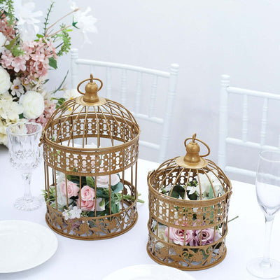 Gold decorative birdcages with flowers on a dining table setting.