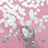 Silver confetti scattered with a wine glass on a pink background.