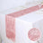 Pink table runner with delicate shimmer on a dining table.