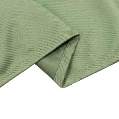 Mint green ribbed fabric close-up with stitched hem
