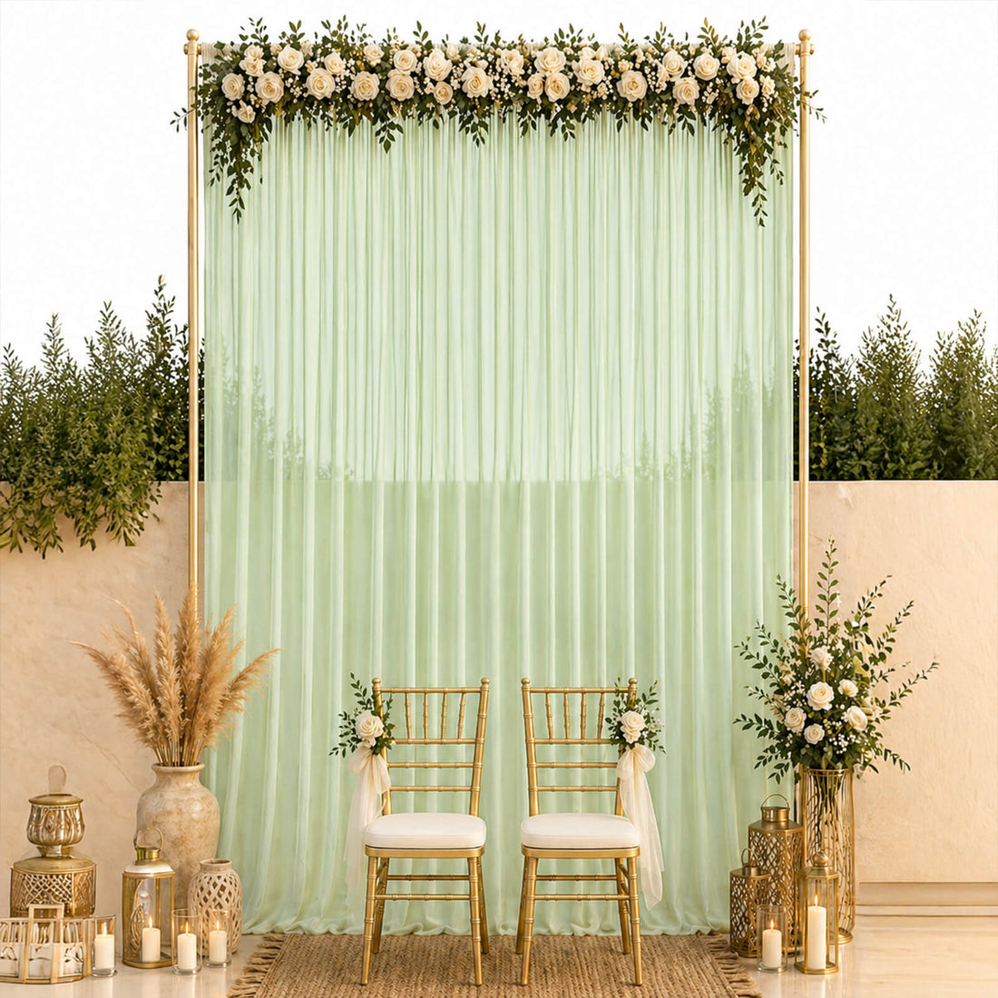 Mint green wedding backdrop with white roses, gold chairs, and lantern decor