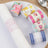 Decorative paper rolls in various floral patterns on a white plate.