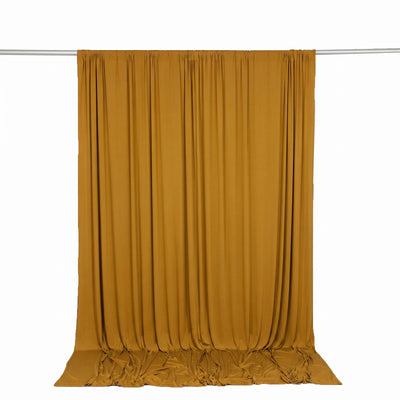 Mustard yellow draped curtain hanging on a rod, isolated on white background
