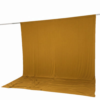 Mustard yellow fabric backdrop draped over a horizontal pole on white background