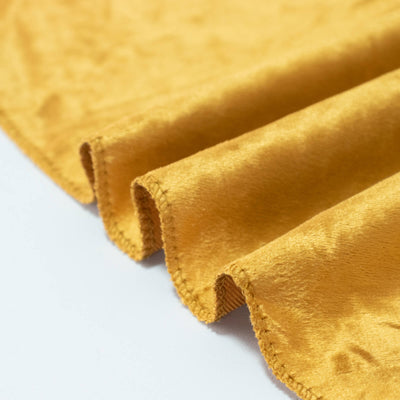 Mustard yellow velvet fabric with stitched pleated folds close-up
